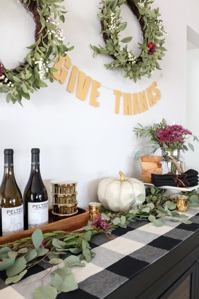 Gold "Give Thanks" banner above a festive table