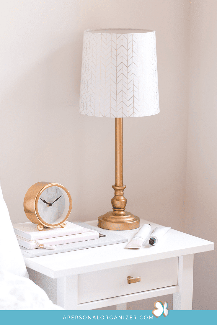 white nightstand with gold accessories